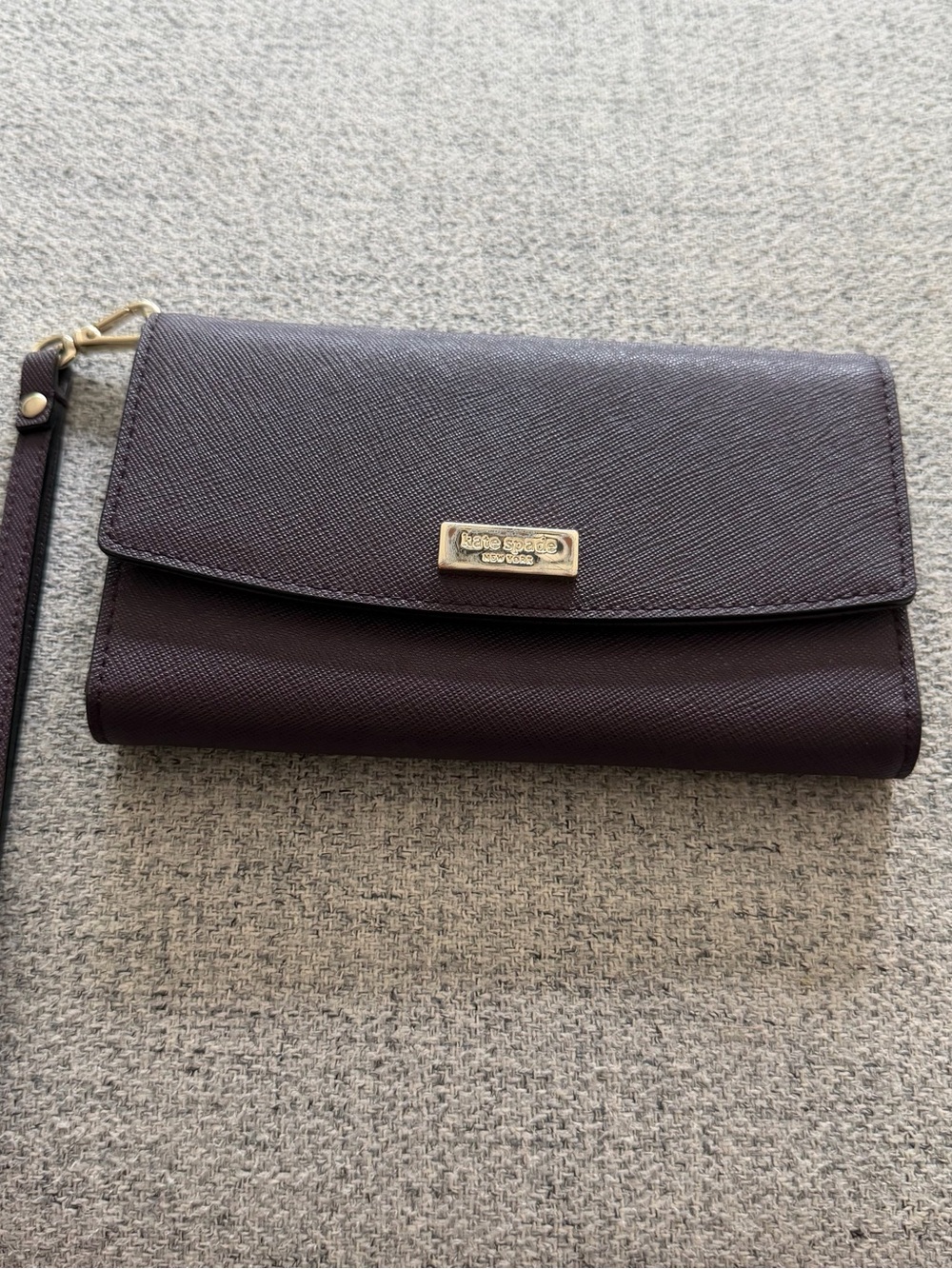 kate spade plum leather wristlet with gold-tone logo